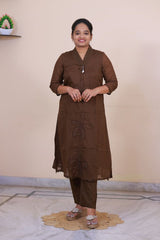 SreeVastra brown mul cotton three-piece dress with embroidered floral details and v-neckline worn by a woman