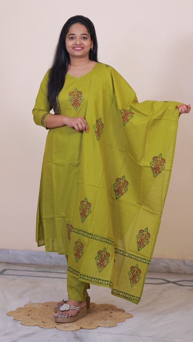 SreeVastra olive green cotton 3-piece dress with floral embroidery and matching dupatta worn by a smiling woman