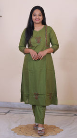 Woman wearing a SreeVastra olive green cotton 3-piece dress with intricate embroidery and three-quarter sleeves