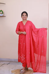 A woman wearing a red SreeVastra cotton 3-piece dress with white floral embroidery and a matching dupatta.