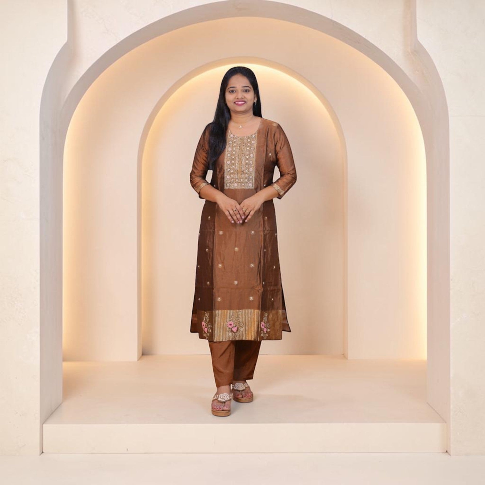 SreeVastra brown silk kurta set featuring intricate gold embroidery on the neckline and floral hem detailing.