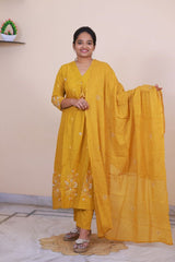 SreeVastra mustard yellow cotton 3-piece dress with white floral embroidery, featuring a kurta, pants, and dupatta.